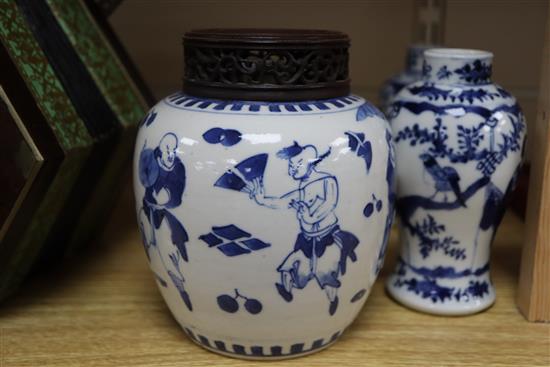 A 19th century Chinese blue and white ovoid jar, wood cover and two similar smaller vases tallest 15cm